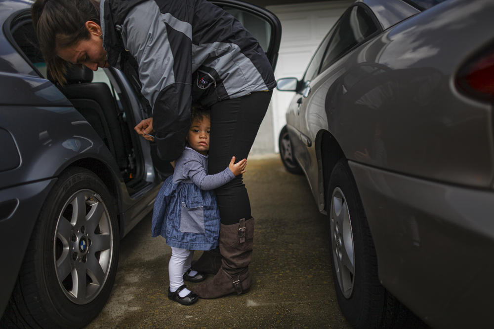 Crystal Turner, a Marine veteran attending classes at Sierra College in Rocklin, Calif., helps her 1 1/2-year-old daughter, Marley Rose, out of a car.