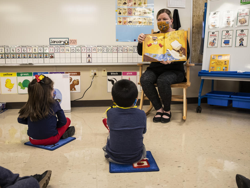 Thousands of pre-kindergarten and some special education students in Chicago Public Schools returned to in-person learning earlier this month. Pre-kindergarten teacher Angela Panush reads a story to her students at Dawes Elementary on January 11.