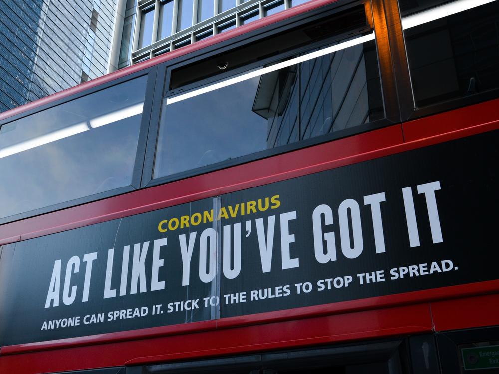 Moderna will test new COVID-19 vaccine booster doses, saying that while its vaccine should protect against variants found in the U.K. and South Africa, it isn't as effective against the South African strain. Here, a bus in London carries a sign telling people, 