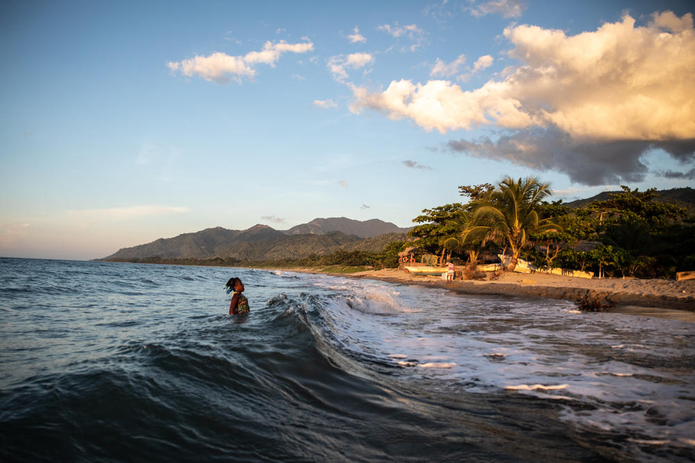 Jirian leaps with the waves behind her family home in Rio Esteban. Even though Ella's two daughters were born and raised in Tegucigalpa's urban mountains, both were quick to take to the water.