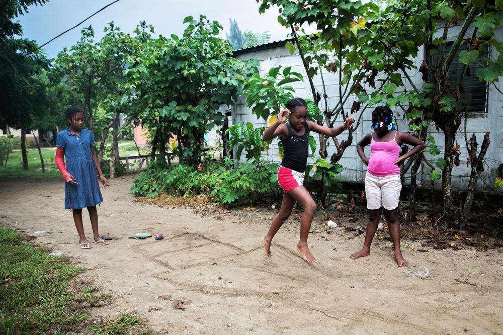 Jirian plays a Garifuna variant of hopscotch with her cousins. Even though she misses her friends in Tegucigalpa, Jirian quickly made new ones in the village of Rio Esteban.