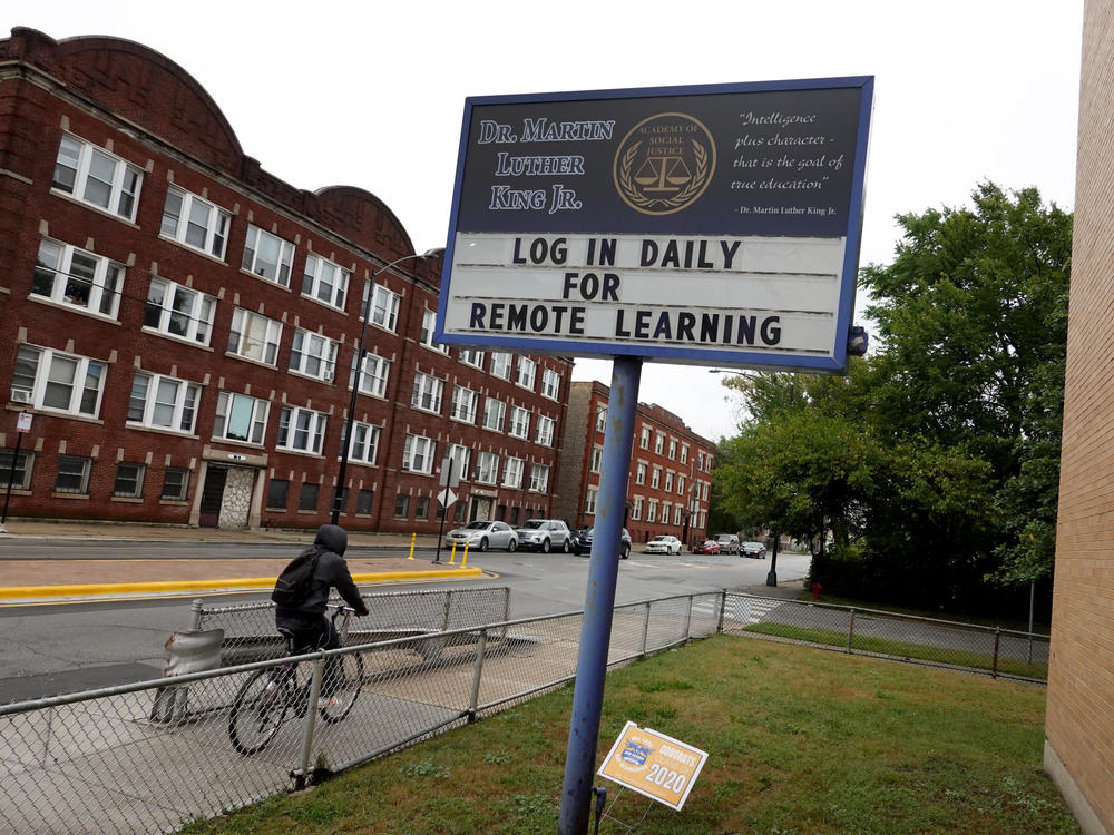 The Chicago Teachers Union voted on Sunday to continue remote work only, in defiance of the school district's plans for K-8 teachers and staff to return to classrooms this week. Here, a sign in front of Martin Luther King, Jr. Elementary School in September.