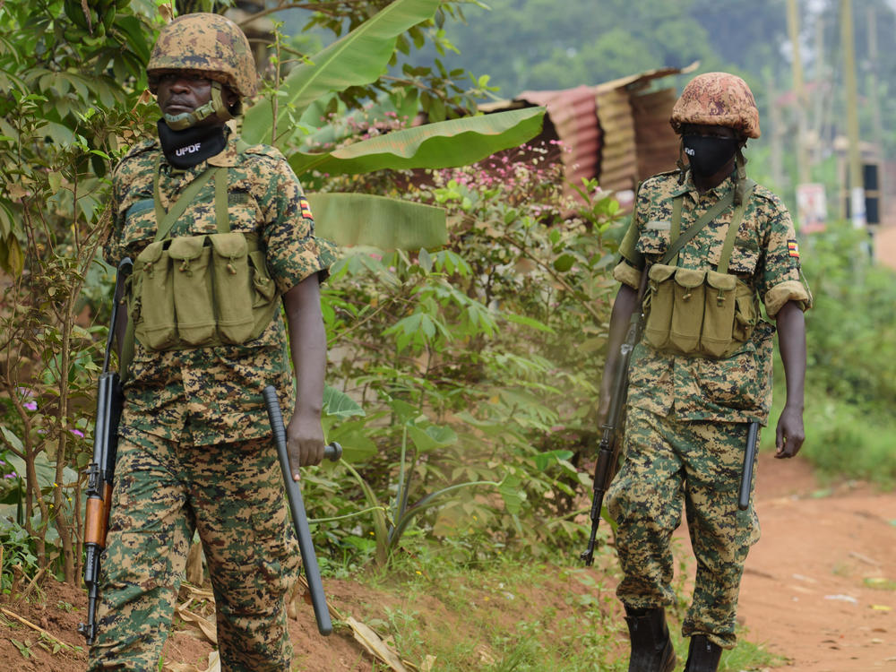 Soldiers patrol outside presidential challenger Bobi Wine's home in Magere, Kampala, Uganda, Jan. 16, after President Yoweri Museveni was declared the winner of the election.
