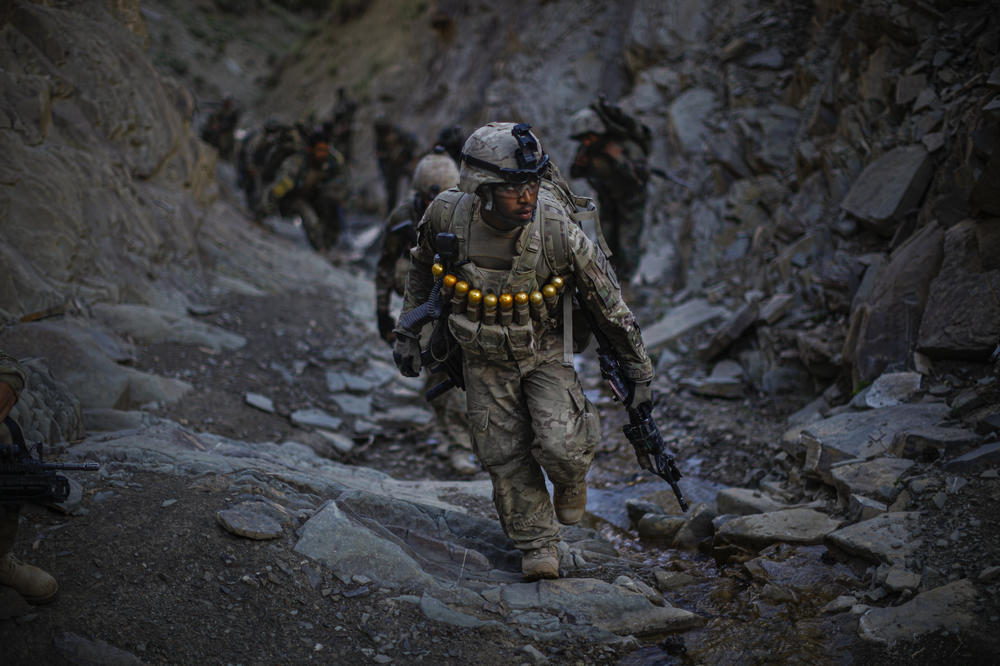 Soldiers with Butcher Troop, part of the U.S. Army 1st Infantry Division, and Afghan National Army troops climb up the treacherous mountains overlooking the Khost-Gardez highway while on a mission to disrupt insurgent fighters in the area in June 2011.