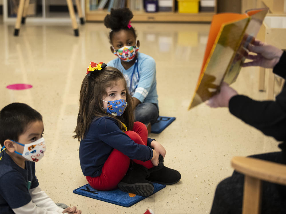Prekindergarten students listen as their teacher reads a story this month at Dawes Elementary School in Chicago.