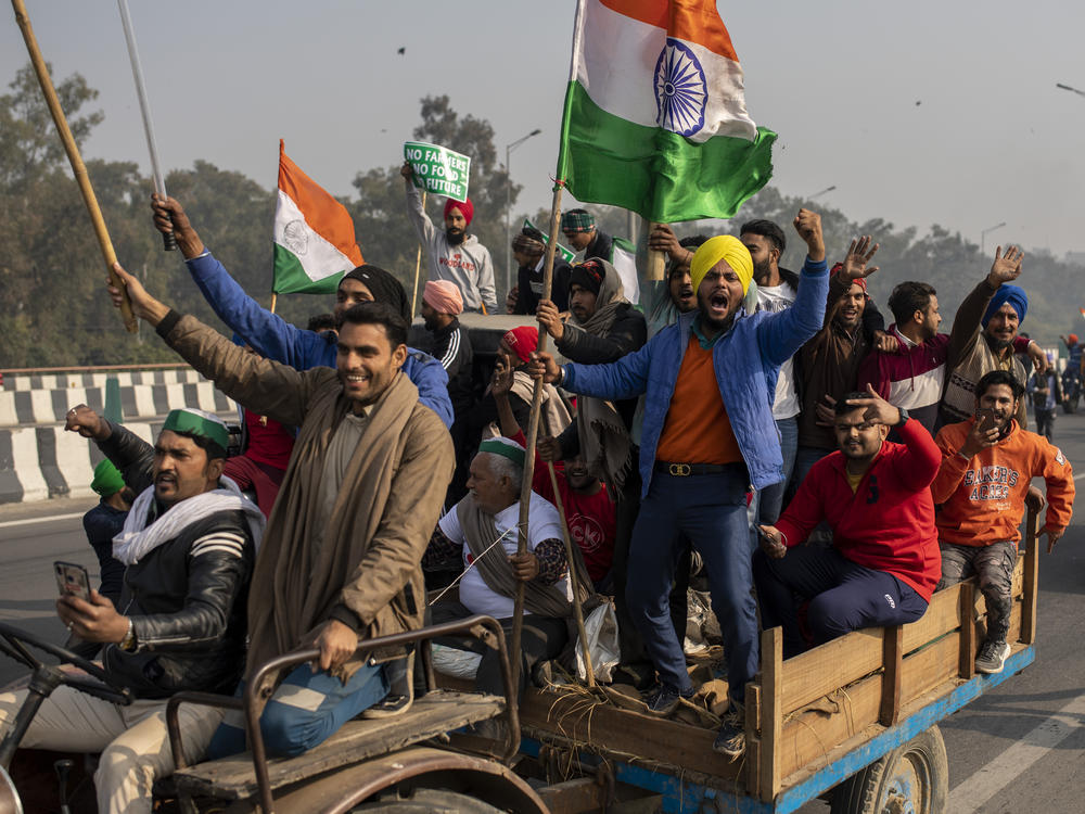 Protesting farmers riding tractors shout slogans as they march to the capital during India's Republic Day celebrations on Tuesday in New Delhi.