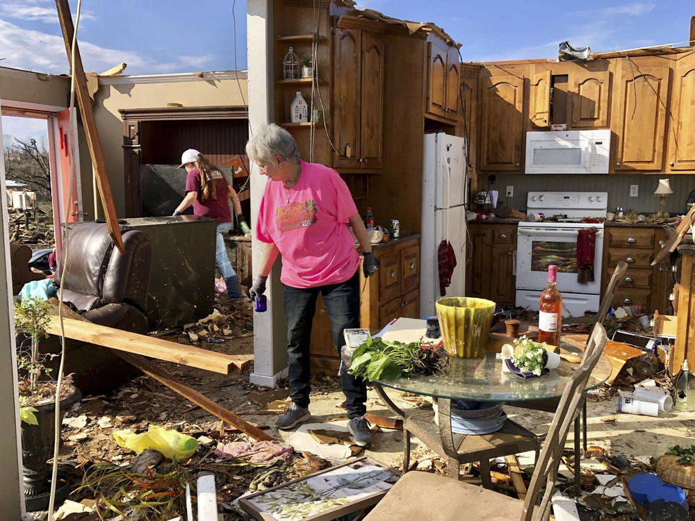 Patti Herring sobs as she sorts through the remains of her home in Fultondale, Ala., on Tuesday, after her house was destroyed by a tornado.