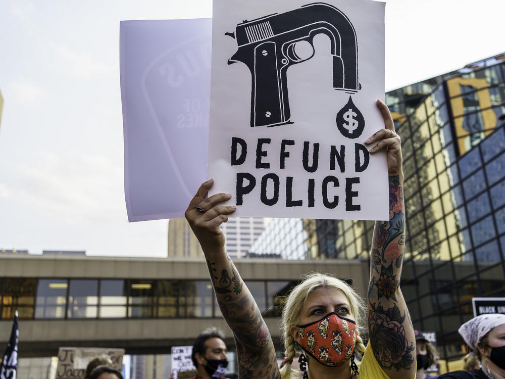 A protester holds a sign reading 