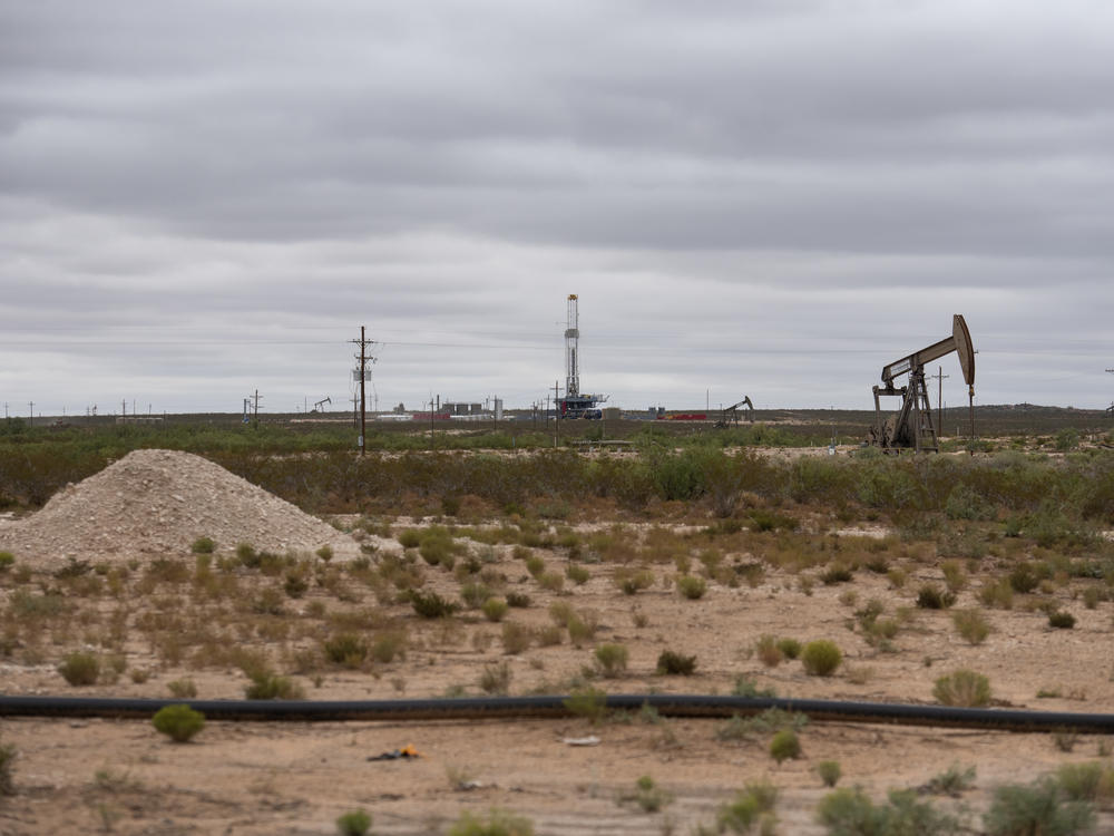 A horizontal drilling rig and a pump jack sit on federal land in Lea County, N.M., in September. The state stands to lose royalties and revenue from a Biden administration pause on new oil and gas leases.