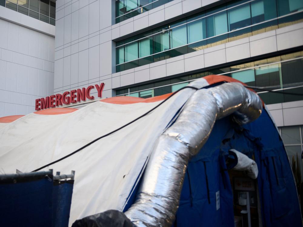 A field hospital tent stands outside the emergency department of the Martin Luther King Jr. Community Hospital earlier this month in Los Angeles. California is returning to a tiered restriction system.