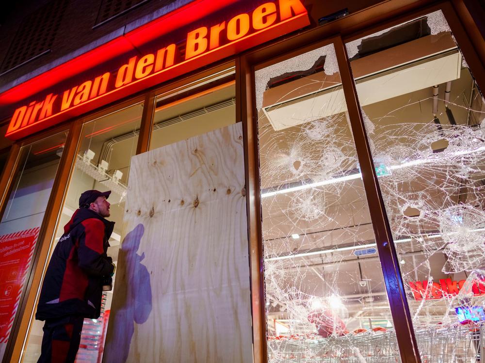 Protesters threw fireworks and rocks at police, damaged storefronts and looted stores during demonstrations on Monday in the Netherlands.