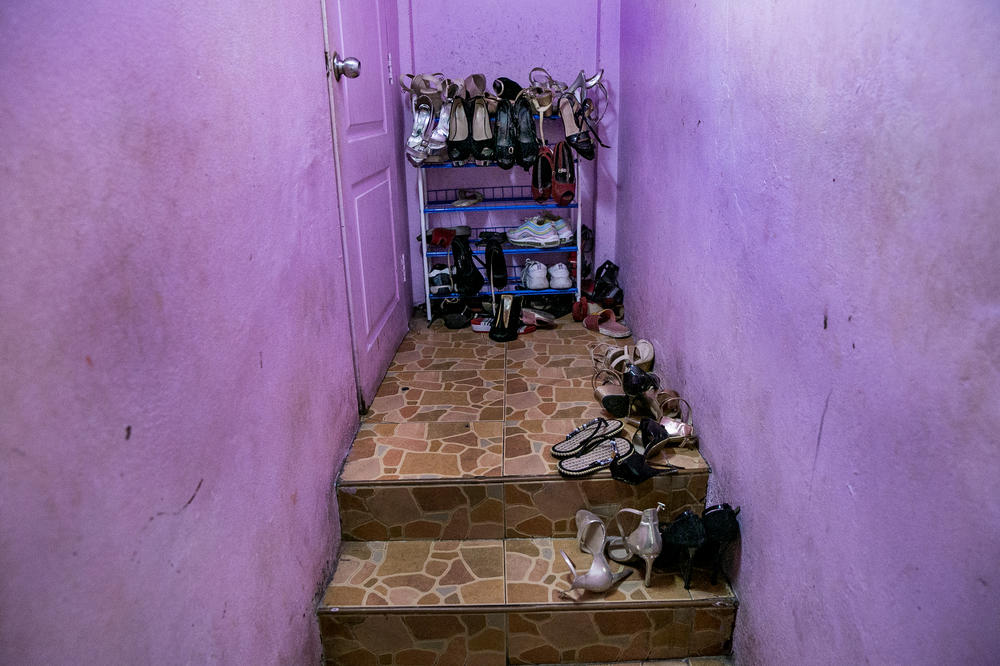 Shoes line the stairway by the living quarters for sex workers at a bar in Pattaya.