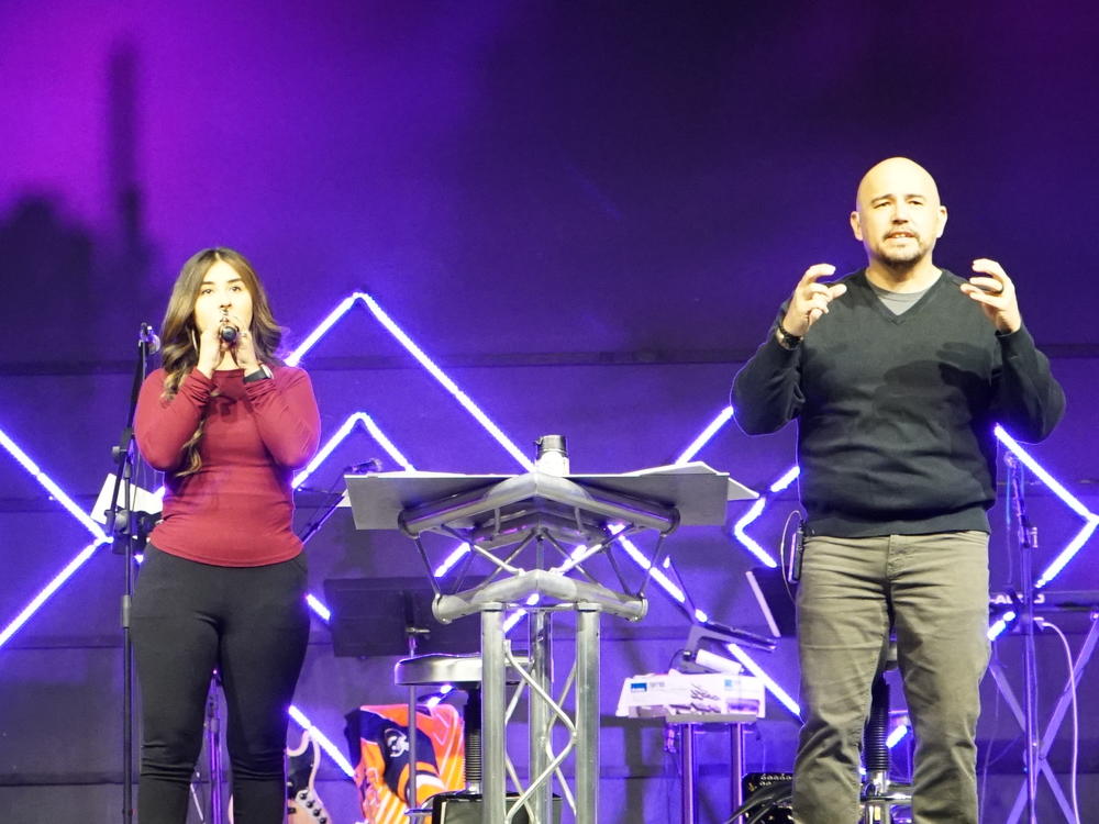 Angel Flores (right), founder and lead pastor of Mosaic Church, delivers the message during the Spanish worship service.