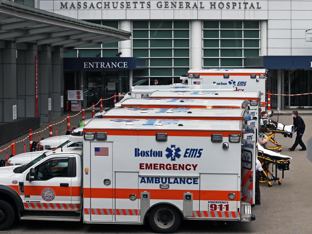 A Boston EMS ambulance crew wheels in a patient to MGH from their ambulance in Boston on April 8, 2020. Hospitals brace for a surge in patients.