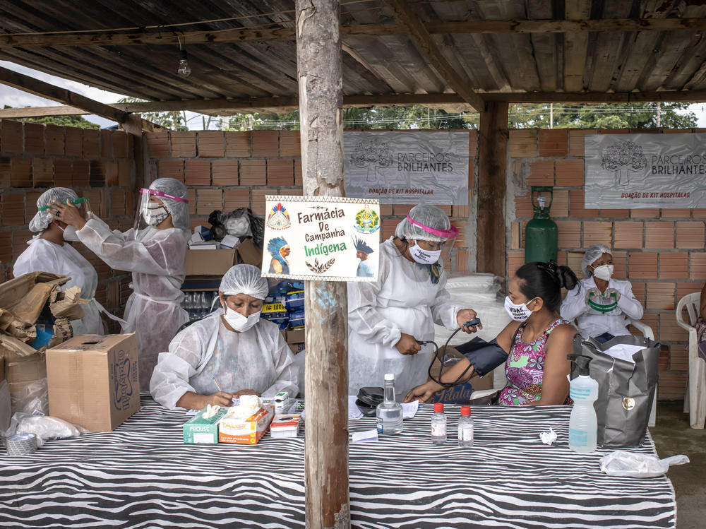 Indigenous health care workers treat patients last week at a campaign hospital set up in the Parque das Tribos neighborhood of Manaus, Brazil. Oxygen shortages at hospitals in Brazil's Amazon prompted authorities to airlift patients to other states.