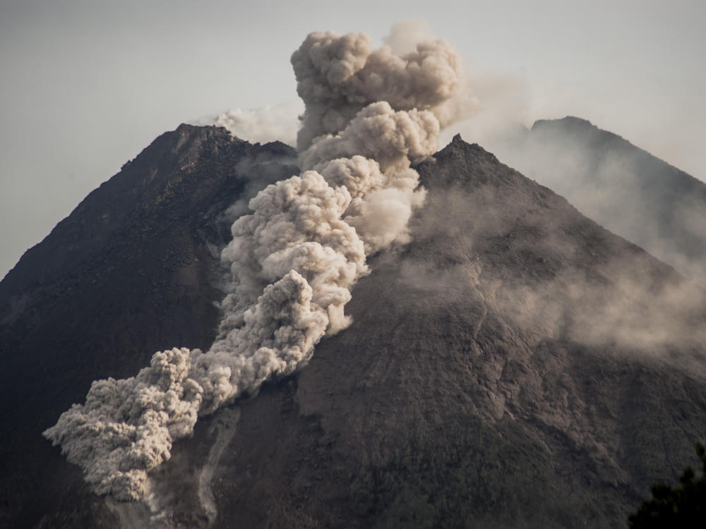 Mount Merapi, Indonesia's most active volcano, spews rocks and gas into Wednesday's morning sky.