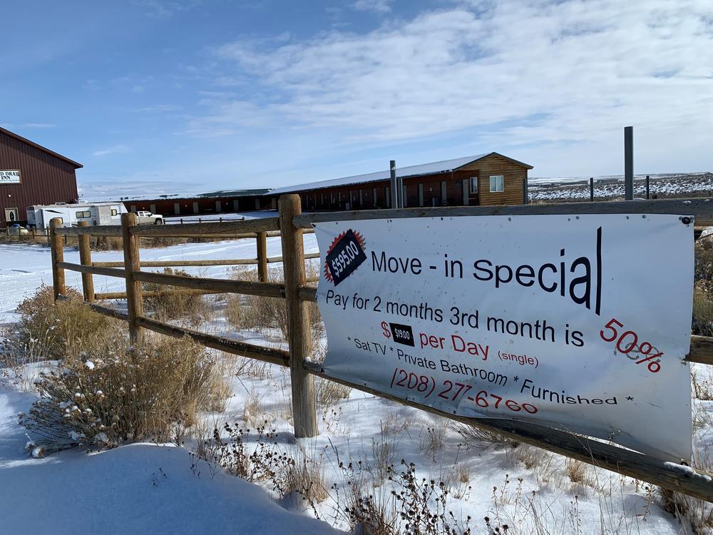 A sign in the Jonah Field advertises cheap rates at a deserted motel built for oil and gas workers.