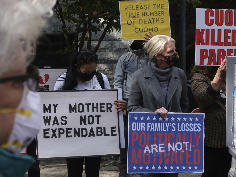 Families of COVID-19 victims who died in New York nursing homes gather in front of the Cobble Hill Heath Center in the Brooklyn borough of New York City in October. A report issued Thursday by New York's state attorney general says health officials undercounted nursing home deaths by as much as 50%.
