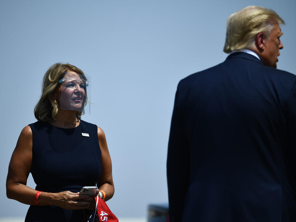 Then-President Donald Trump is greeted by Kelli Ward, chair of the Arizona Republican Party, during a stop in Arizona last year.