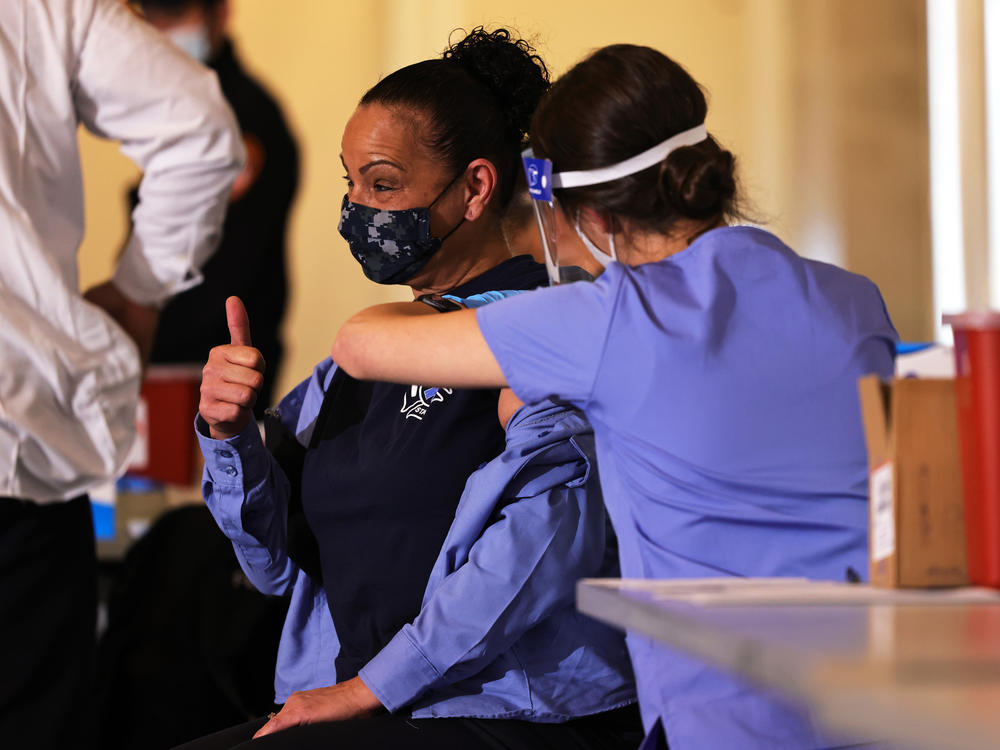 A member of FDNY EMS gives a thumbs up while receiving Moderna's vaccine against the coronavirus in late December. By mid-January, New York City Medical Reserve Corps volunteers also were mobilized to help with the vaccine effort.