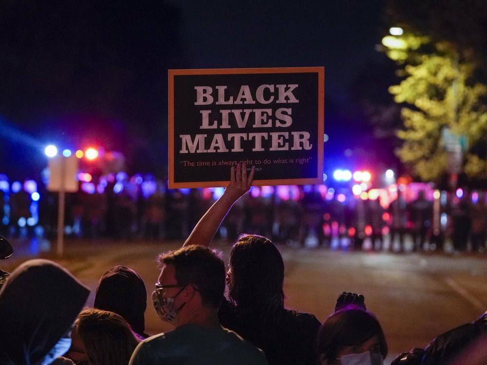 Protesters and police face off in Wauwatosa, Wis., in October, after the district attorney refused to charge Officer Joseph Mensah in the shooting death of Alvin Cole early last year.