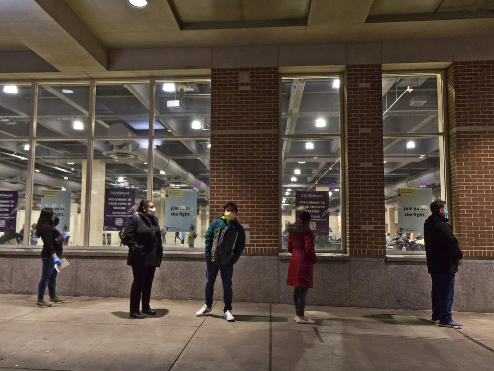 Home health workers wait in line outside the convention center in Philadelphia at the Jan. 8 vaccination clinic held by Philly Fighting Covid, a startup company.