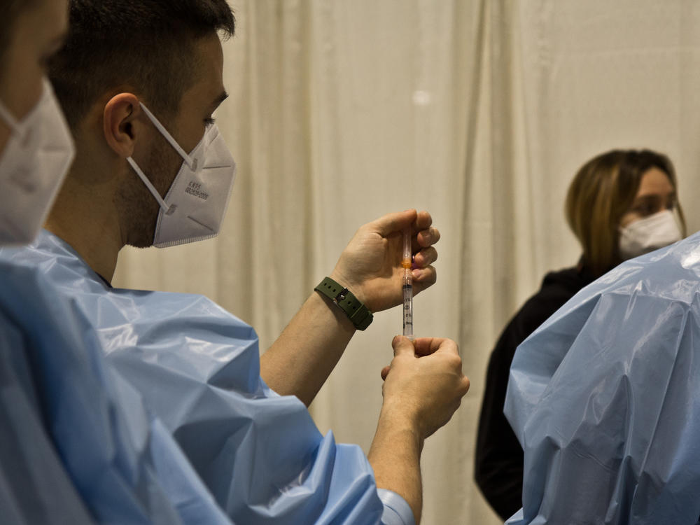 A nurse demonstrates how to administer a COVID-19 vaccination at a clinic organized by Philly Fighting Covid on Jan. 8 at the Pennsylvania Convention Center.