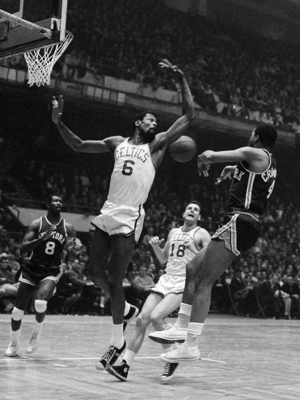 Russell tries to swat away a pass by Fred Crawford of the New York Knicks in 1967.