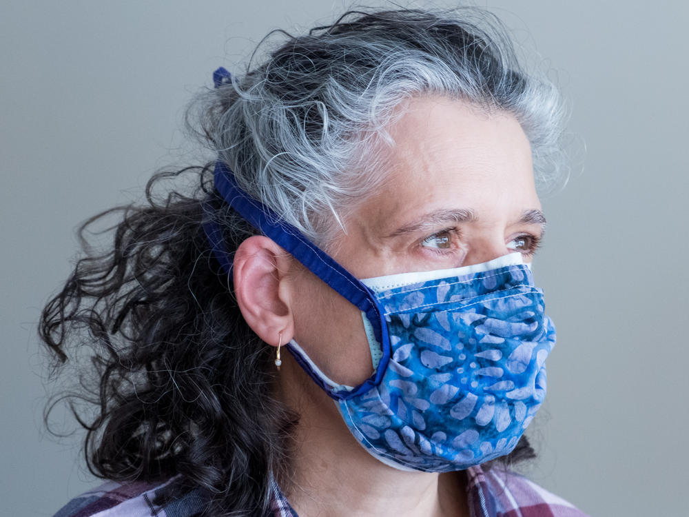 Layering a cloth mask on top of a surgical mask helps achieve a tighter fit while also adding an extra layer of filtration. Double-masking like this increases protection against the coronavirus.