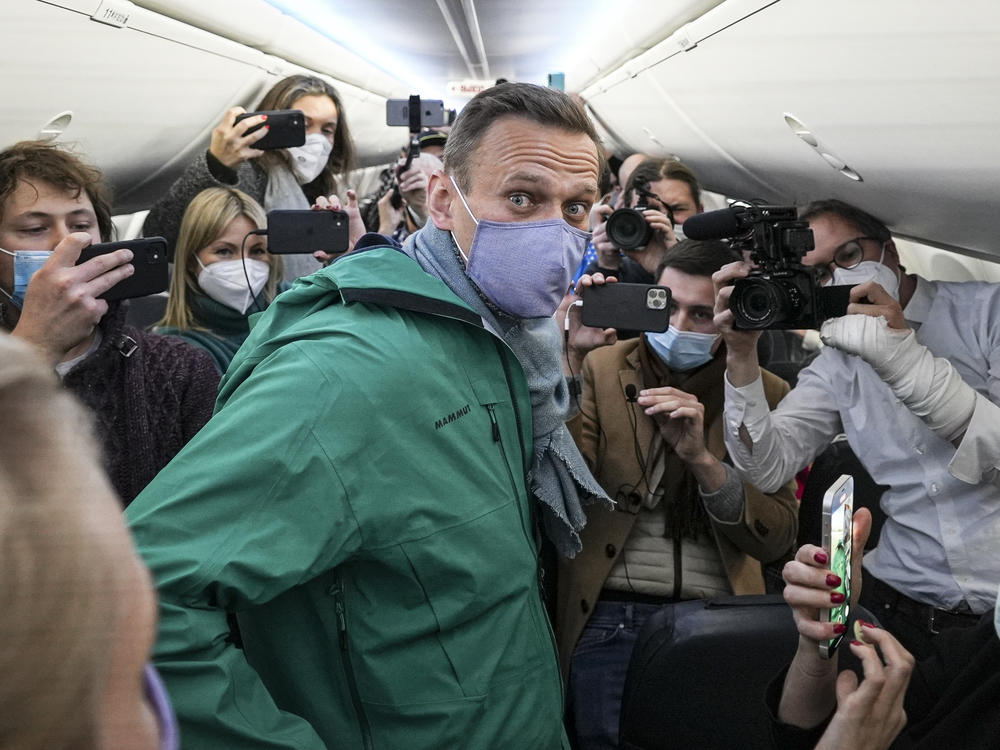 Alexei Navalny is surrounded by journalists on a plane Jan. 17 before a flight to Moscow at Berlin Brandenburg Airport. Navalny was arrested upon his return to Russia.