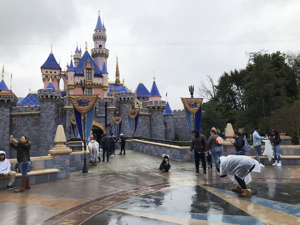 Visitors take photos at Disneyland in Anaheim, Calif., in March 2020. Jungle Cruise, one of the original Disney parks' rides, is getting a 21st century remodel by 