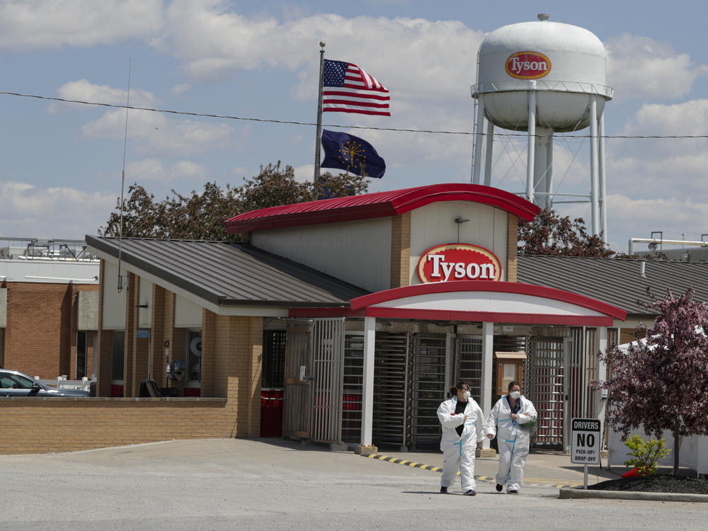 Workers are shown leaving the Tyson Foods pork processing plant in Logansport, Ind., in May. A House subcommittee is investigating the Trump administration's handling of COVID-19 outbreaks at meatpacking plants, focusing on the Occupational Safety and Health Administration as well as major companies Tyson, Smithfield and JBS.