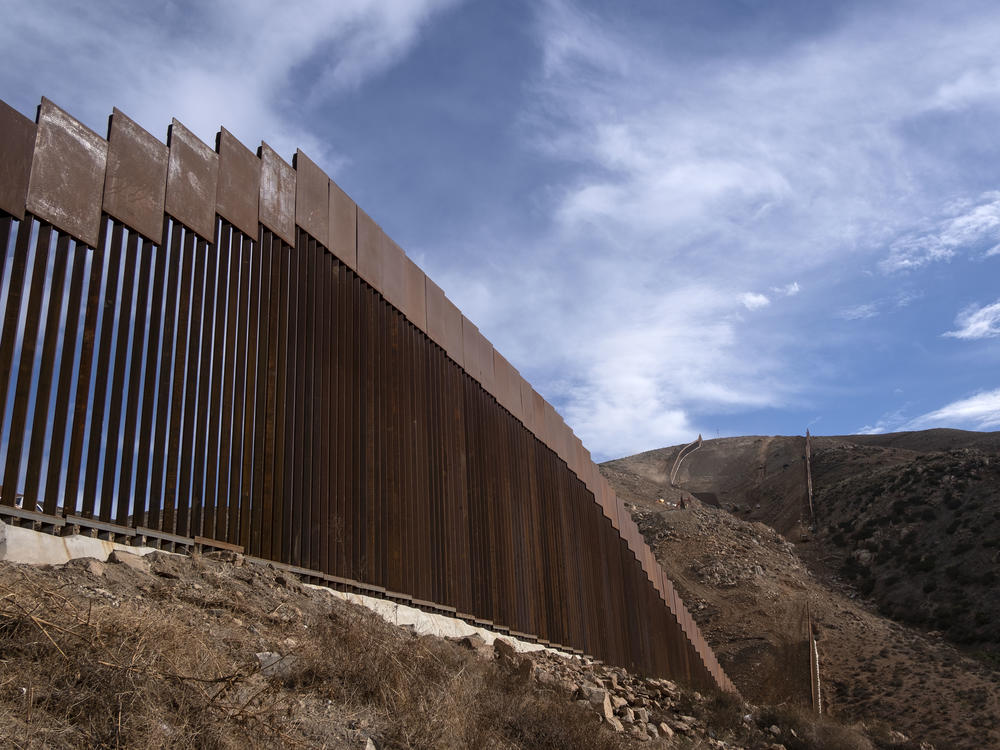 A reinforced section of the U.S.-Mexico border fencing seen in eastern Tijuana, Baja California, Mexico on Jan. 20. President Biden signed an executive action and has halted construction of the massive wall for 60 days.