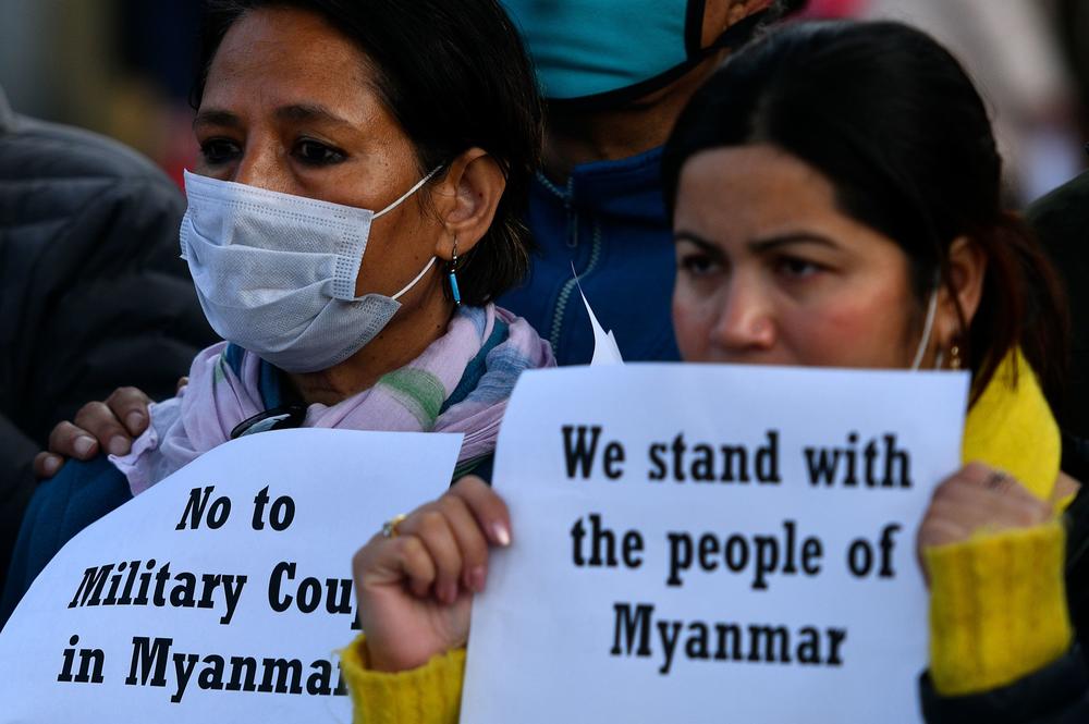Protesters hold placards in Kathmandu, Nepal, on Monday, after Myanmar's military seized power in a bloodless coup, detaining democratically elected leader Aung San Suu Kyi as it imposed a one-year 