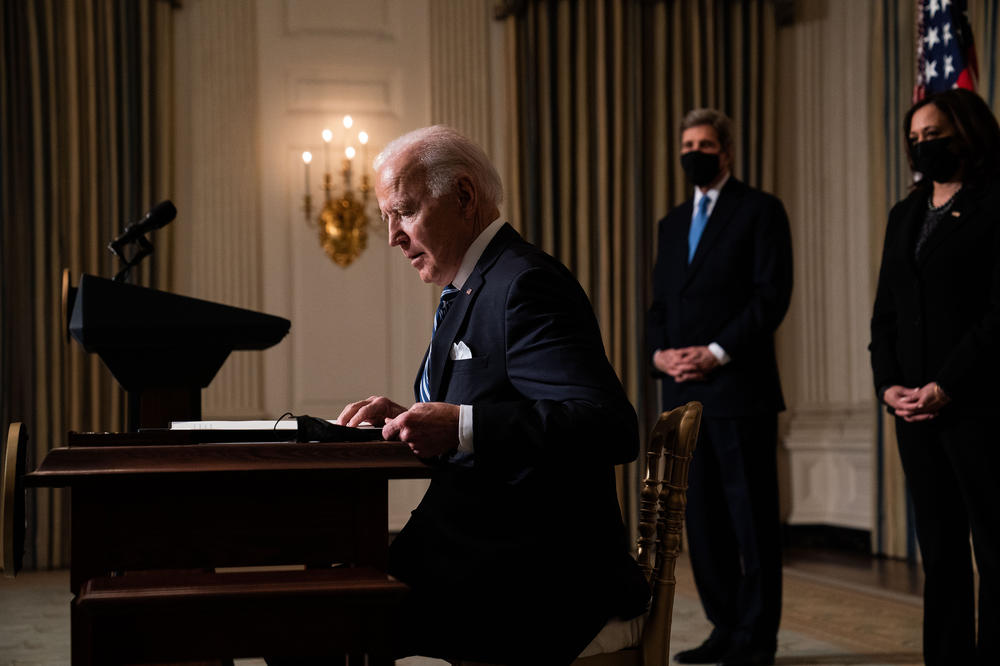 President Biden prepares to sign executive orders after speaking about climate change issues in the State Dining Room of the White House on Jan. 27.
