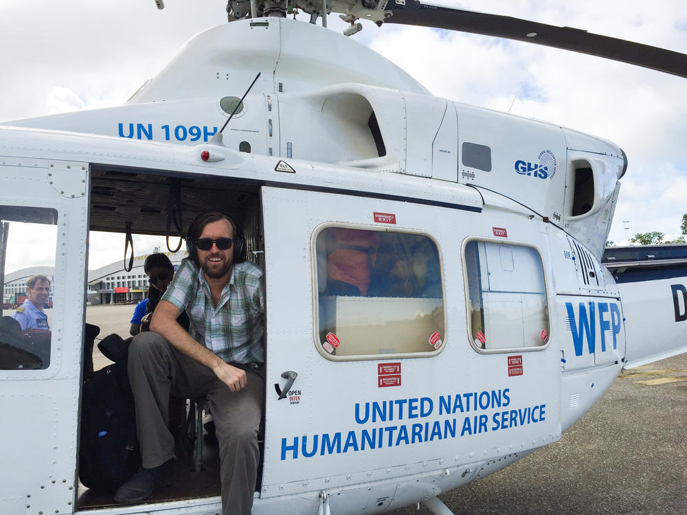 Dr. Eugene Richardson in a helicopter during the Ebola outbreak in Sierra Leone, where he worked as a clinical lead for Partner in Health's response to the outbreak. He is the author of the new book <em>Epidemic Illusions: On the Coloniality of Global Public Health.</em>