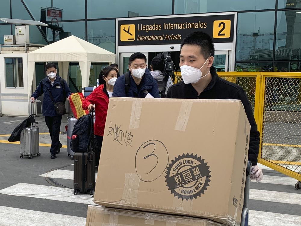 Members of a Chinese medical delegation arrive at the Lima airport with COVID vaccines for part of a clinical trial this fall. Peru hosted trials for several manufacturers in part to increase its chances of getting access to a successful inoculation.
