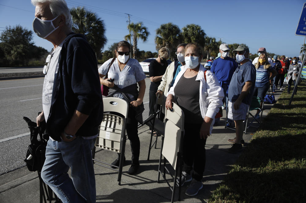 Seniors and first responders try to snag one of 800 doses available at a vaccination site in Fort Myers, Fla.