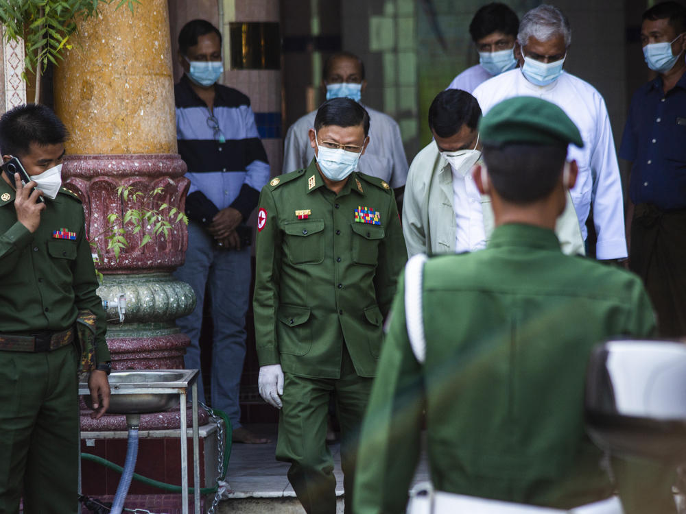 Myanmar's de facto leader, Aung San Suu Kyi, is charged with illegally importing walkie-talkie radios, in the first formal charges against her since the military ordered her detention. Here, a military commander visits a Hindu temple in Yangon.