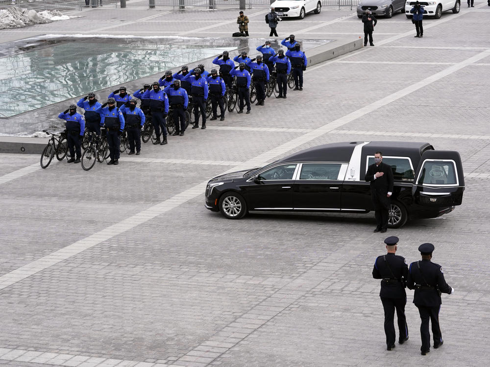 An honor guard carries an urn with the cremated remains of U.S. Capitol Police Officer Brian Sicknick down the steps of the U.S Capitol.
