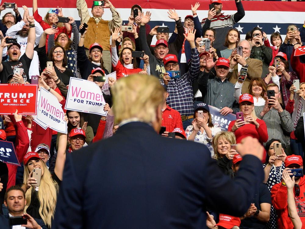Supporters cheer as former President Trump arrives to address a 
