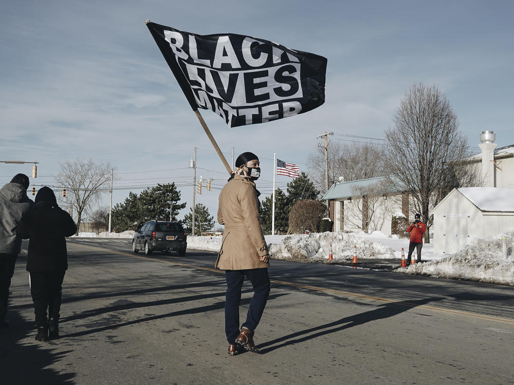 Diallo Payne marches to a small protest outside Rochester Police Locust Club, the police union that represents members of the Rochester Police Department.
