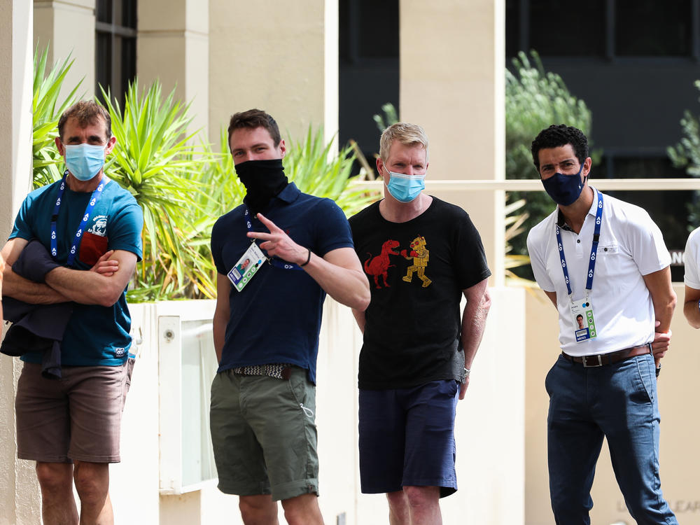People associated with the Australian Open are seen lining up at a testing facility at the View Hotel on Thursday in Melbourne, Australia. Victoria state has reintroduced COVID-19 restrictions after a hotel quarantine worker tested positive for the coronavirus on Wednesday.