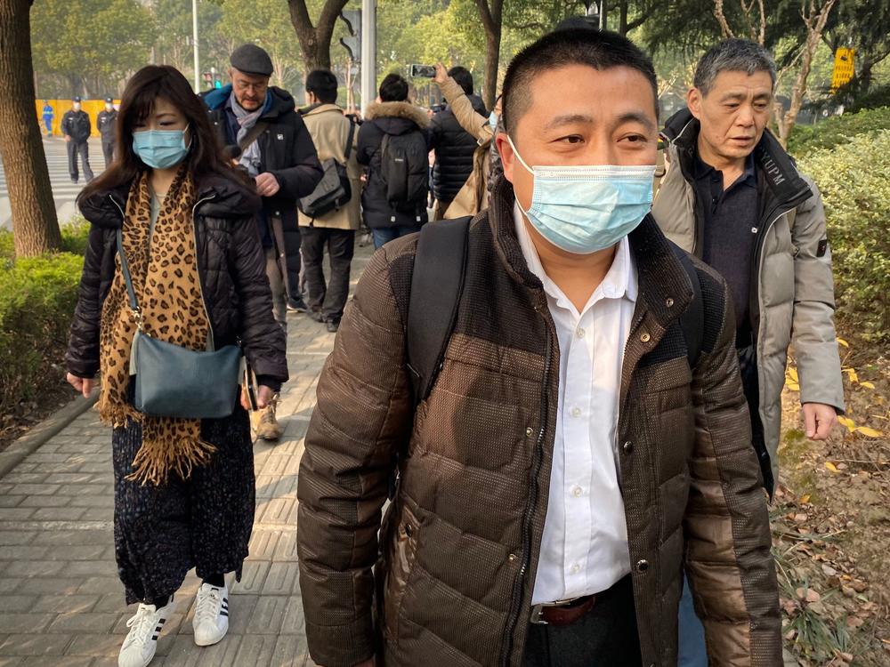 Lawyer Ren Quanniu (center), representing Chinese citizen journalist Zhang Zhan who reported on Wuhan's COVID-19 outbreak and was placed in detention since May, arrives at the Shanghai Pudong New District People's Court where Zhang is set for trial in Shanghai on Dec. 28. Ren has since been disbarred.