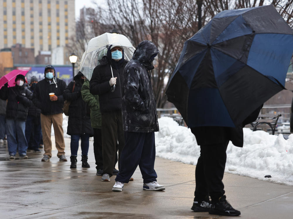 People wait in line to enter a COVID-19 vaccination site at Yankee Stadium on Friday in the Bronx borough of New York City.