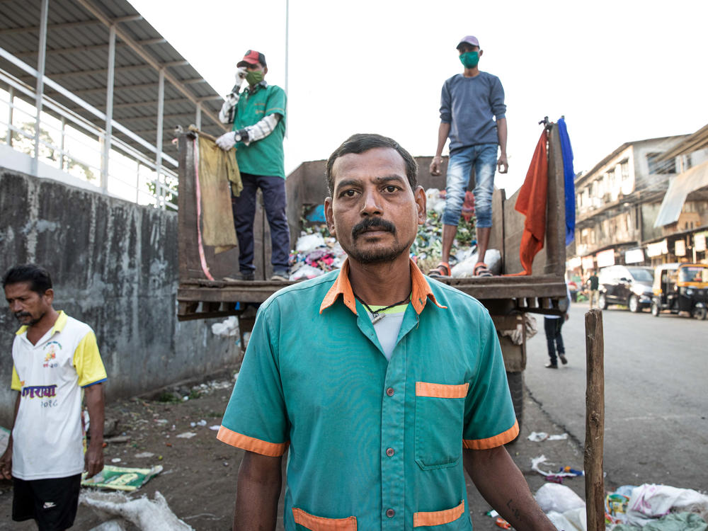 Sanitation worker Ramesh Solanki cleans the streets outside Palghar railway station. 