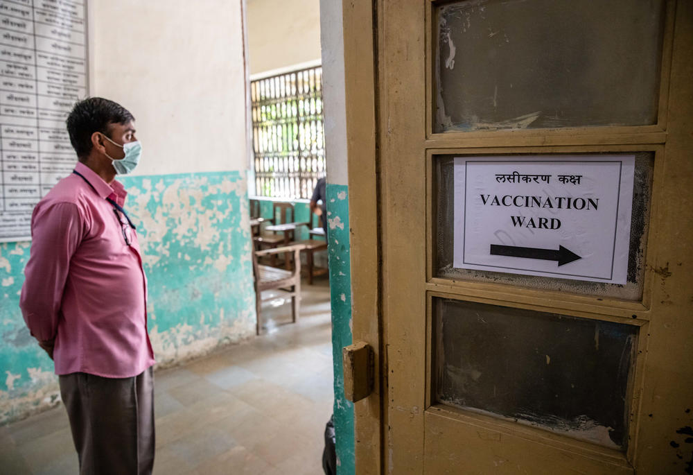 A man stands outside the vaccination ward.