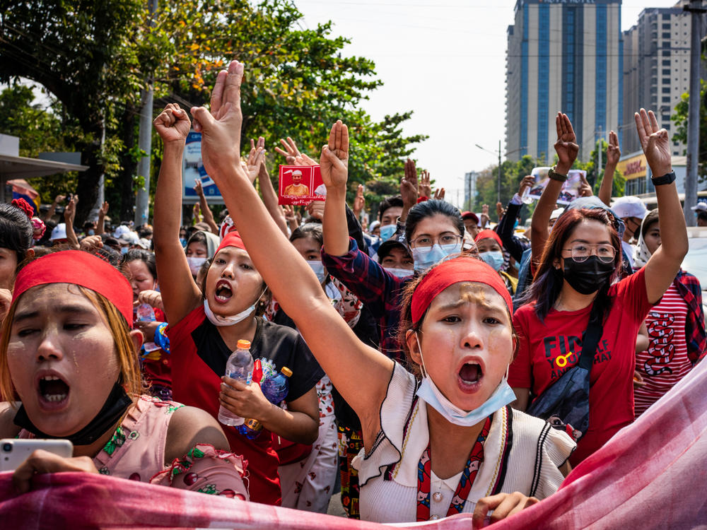 People make three-finger salutes during an anti-coup march on Saturday in Yangon, Myanmar.