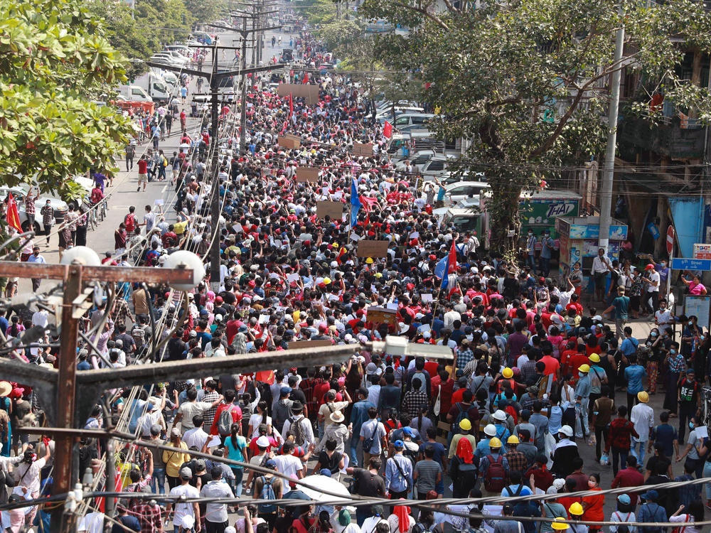 Protesters march toward Sule Pagoda in Yangon on Sunday.