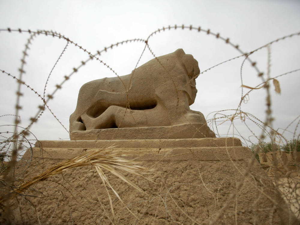 Barbed wire surrounds the Lion of Babylon, seen in 2012 at the archaeological site of Babylon.